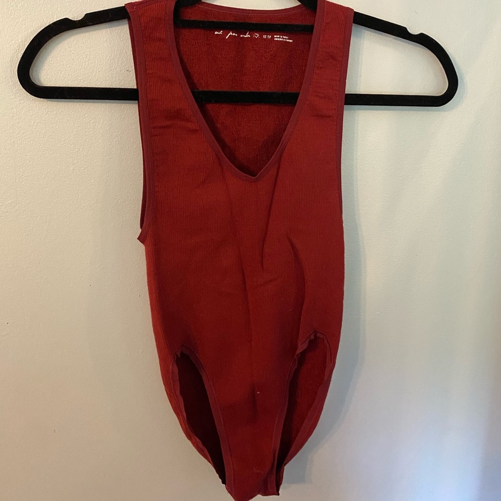 Deep red body suit with side boob exposed